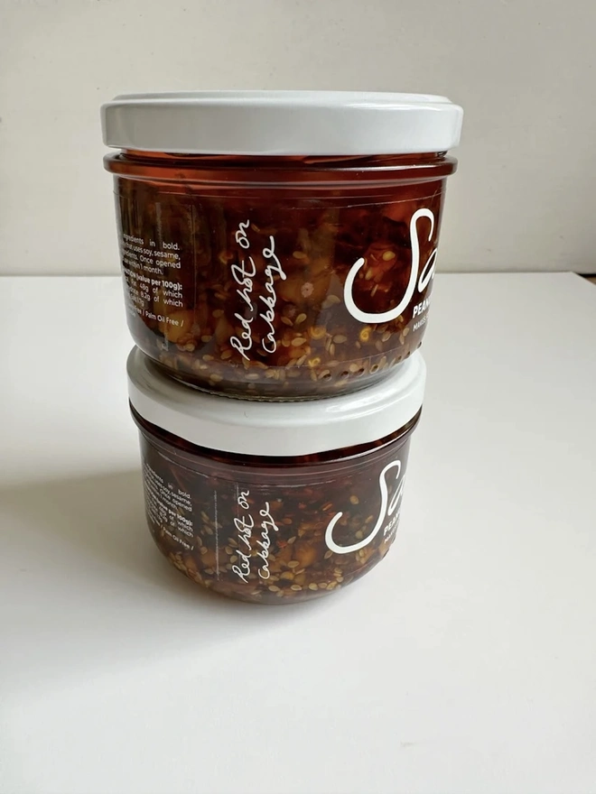 Peanut Salsa (Set Of 2), a pair of peanut salsas sitting on a white table against a grey backdrop. 