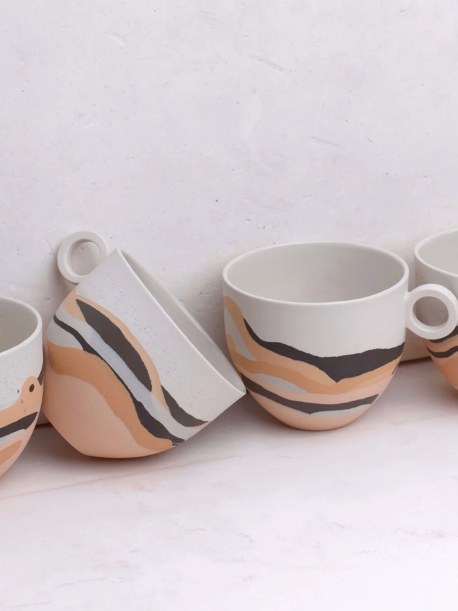 Desert Dreamlands Mug. Four mugs of the same collection with slightly different decoration.