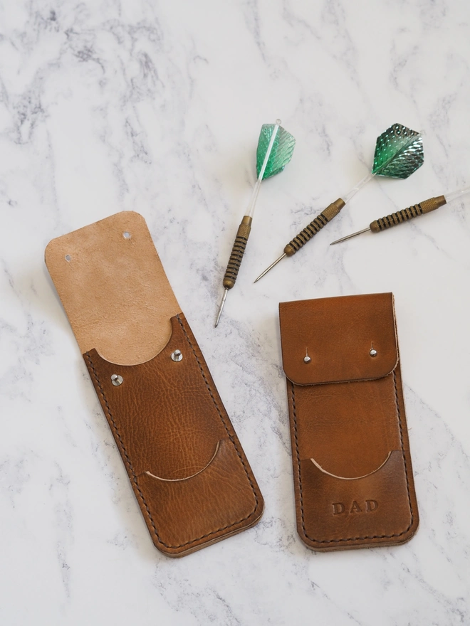 Personalised tan brown leather darts case. Two slim leather sleeves handmade for holding a set of three darts and flights.
