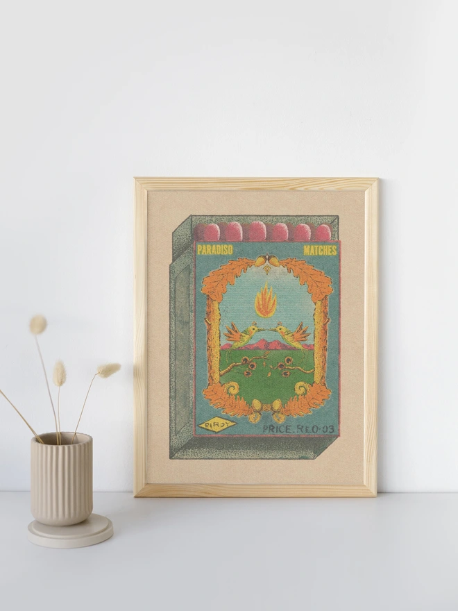 Step into a dreamlike vintage world with Paradiso Matches – Birdy, a richly detailed print inspired by old matchbox labels and folk-art iconography. Two mirrored birds hover mid-air beneath a floating flame, framed by curling vines, golden leaves, and distant rose-colored mountains. The composition feels symbolic and timeless—part love story, part talisman.  Muted greens and sky blues contrast with warm ochres and reds, all layered with a soft, grainy texture that evokes antique printing and quiet nostalgia. Equal parts playful and mystical, this artwork invites slow looking and rewards it with intricate detail and balance.  Perfect for collectors of vintage-inspired art, nature lovers, or anyone drawn to symbols of connection, warmth, and spark.