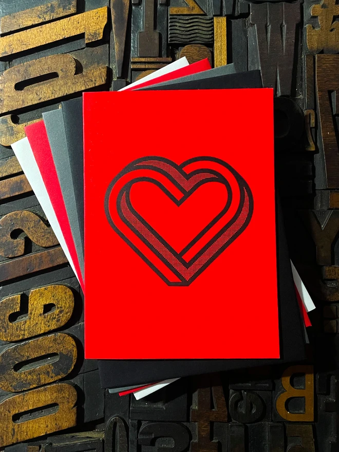 Valentine! A beautiful infinity heart monogram letterpress card printed with rich black ink on thick vibrant Gmund Action Electric Blood colourful card with a luxury matching envelope; ideal to send a to a friend or loved one.