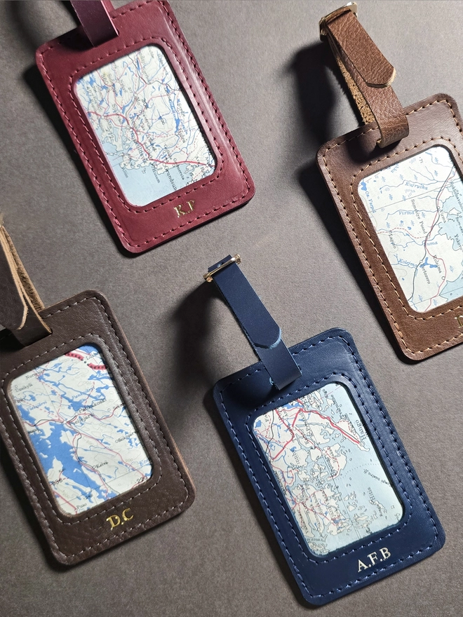 a red brown tan and blue leather luggage tag featuring a section of a original silk war escape map