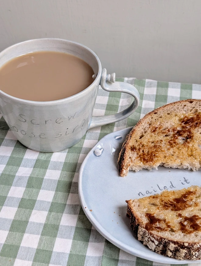 Nailed it plate with ceramic nail pun plate and grey translucent glaze with a piece of marmite on toast