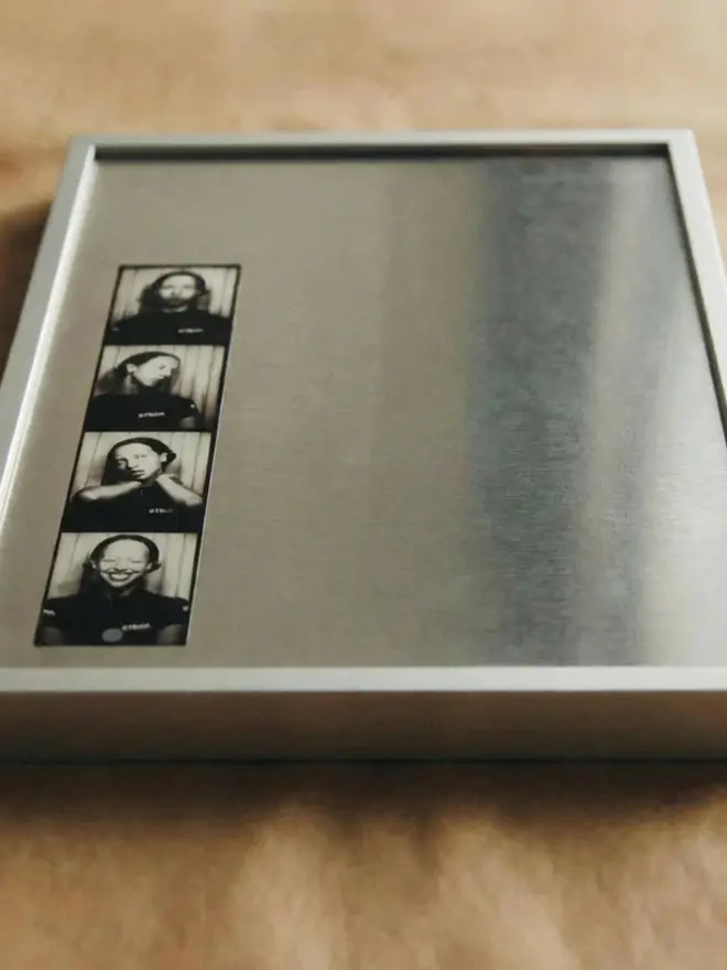 Magnetic Aluminium Picture Frame, displayed on a wooden table. 