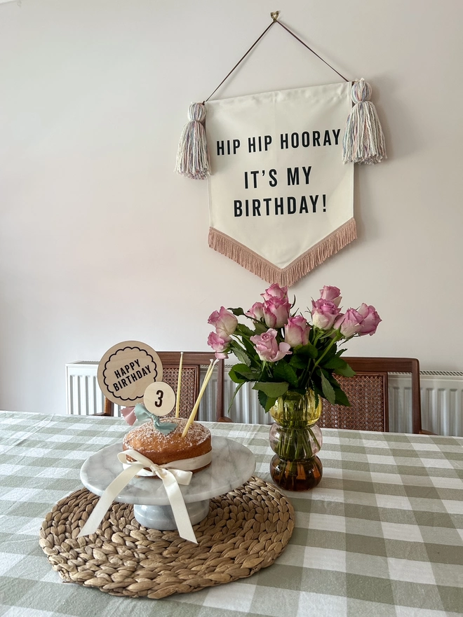 Large handmade fabric birthday banner for birthday celebrations and parties with pastel tassels and rose gold trim 