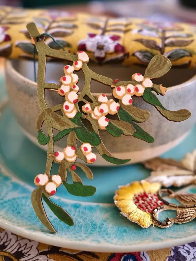 Wooden Mistletoe Decoration seen on a bowl