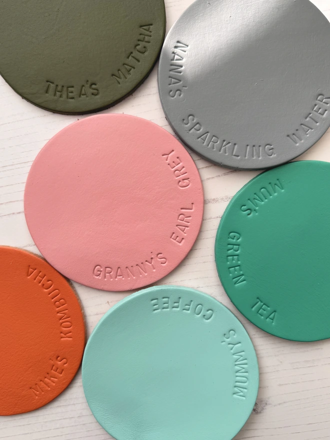 6 leather coasters, each hand stamped with a different message, such as Mummy's coffee and Thea's Matcha. 