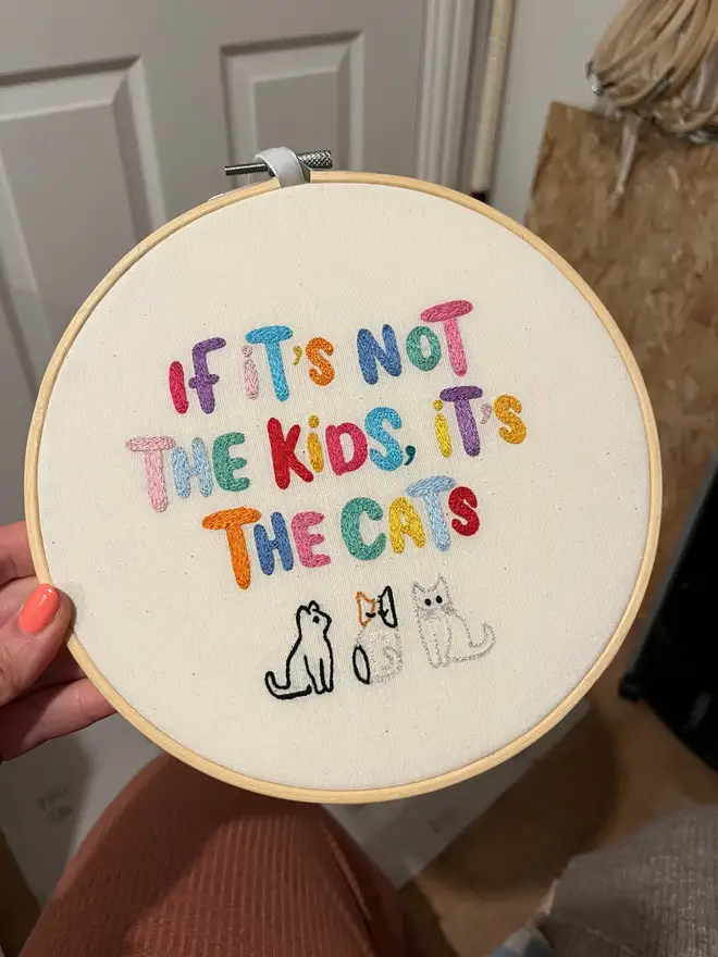 custom embroidered hoop. cotton hoop embroidered with multi coloured lettering.