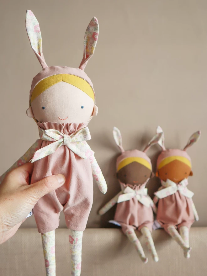 fabric bunny doll with blonde hair and pink floral outfit