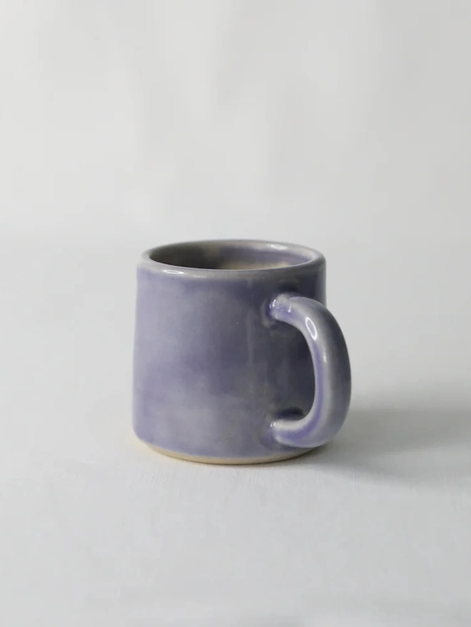 Classic Ceramic Espresso Mug, a colourful ceramic espresso mug sitting on a plain surface against a white backdrop. 