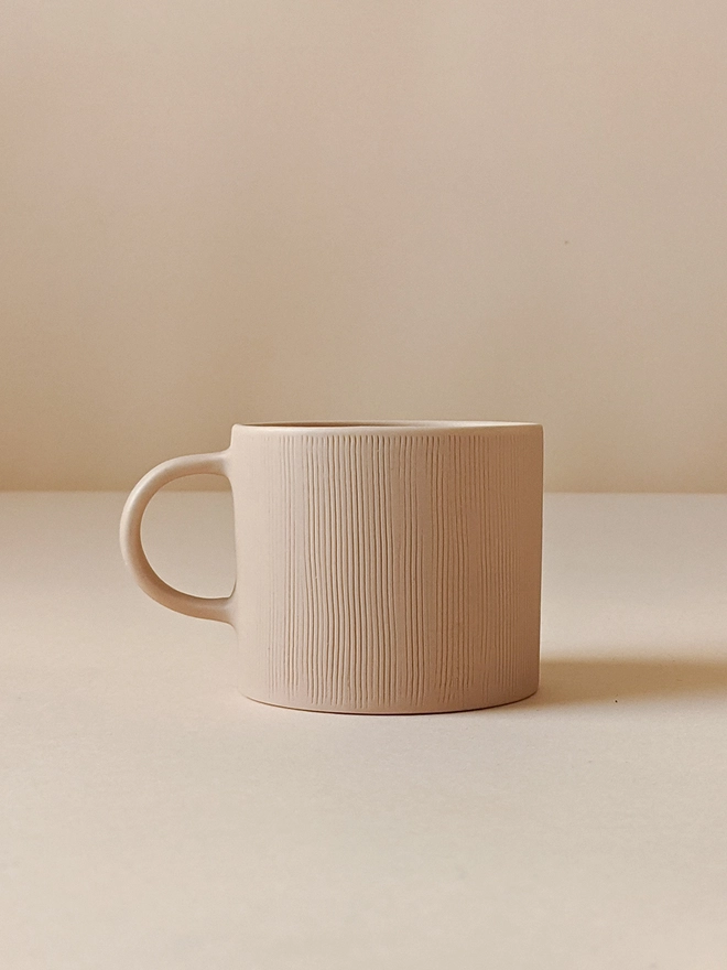 Small Porcelain Coffee Cup in Pale Oat with Hand Carved Combed Texture