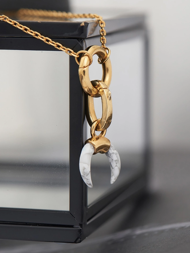 Howlite charm on gold necklace