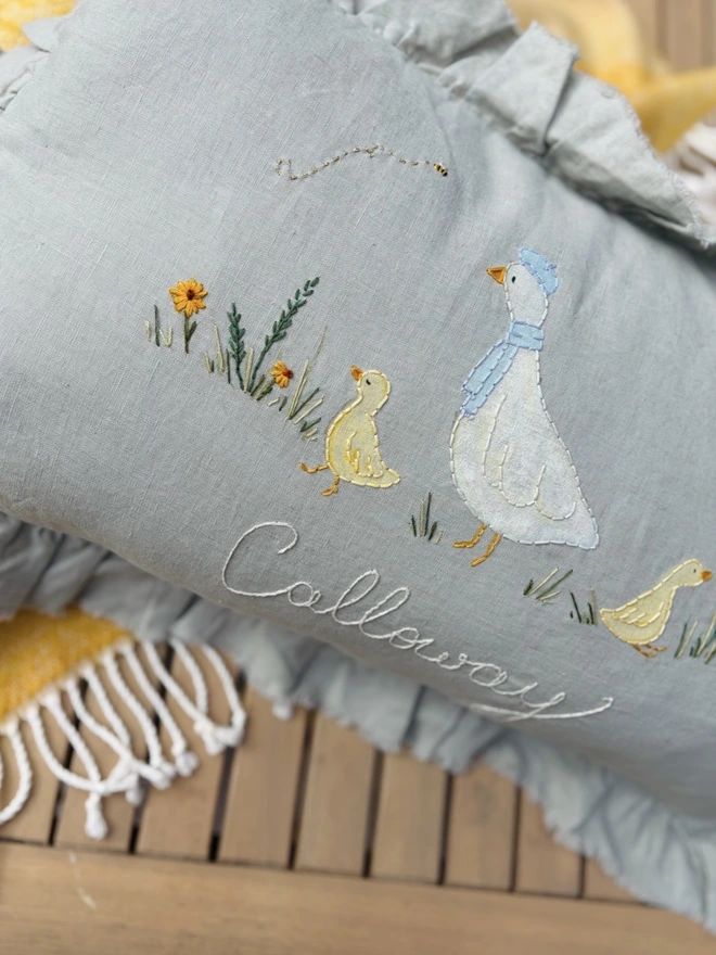 Hand Painted and Hand Embroidered Goose with baby geese on green linen cushion. Yellow flowers and bees. 
