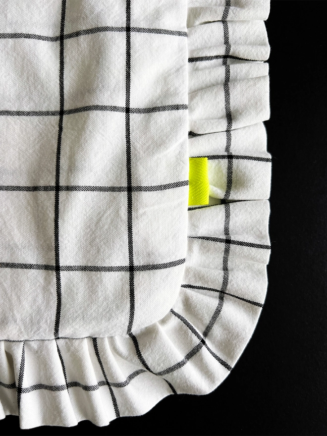 Close up detail of grid pattern cloth tote bag