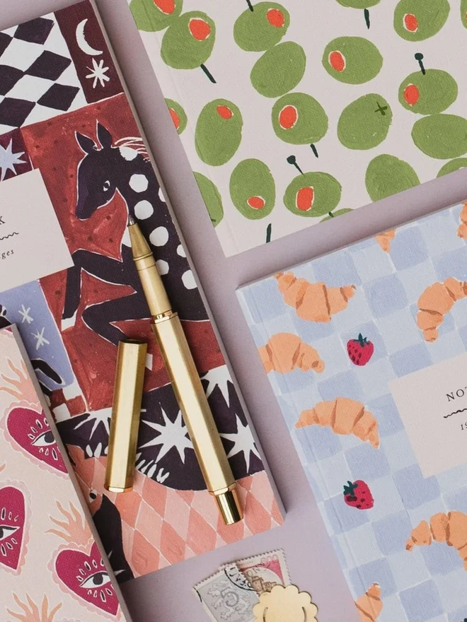 Croissant Cafe Notebook with a gold pen and Sister Paper Co cards