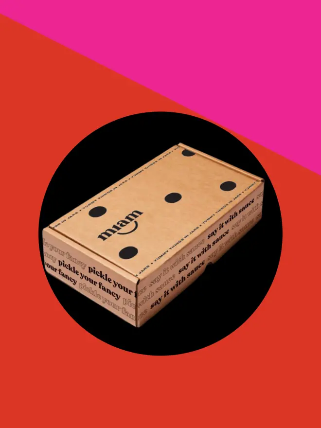 giftbox on a pink and red background with a black circle
