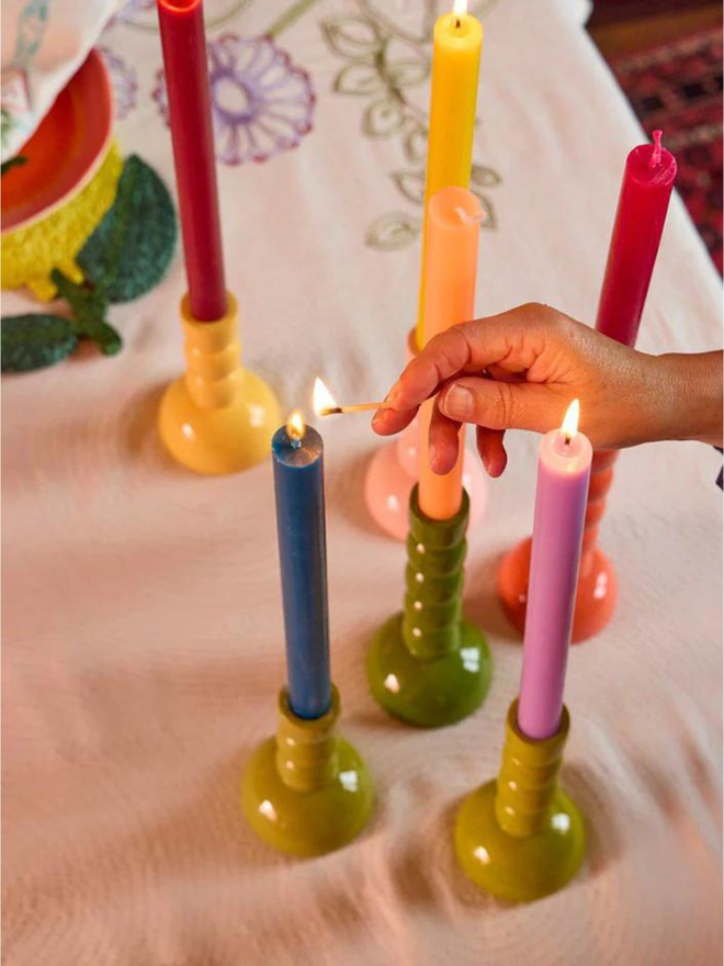 wooden candlestick holders in variety of colours lifestyle shot