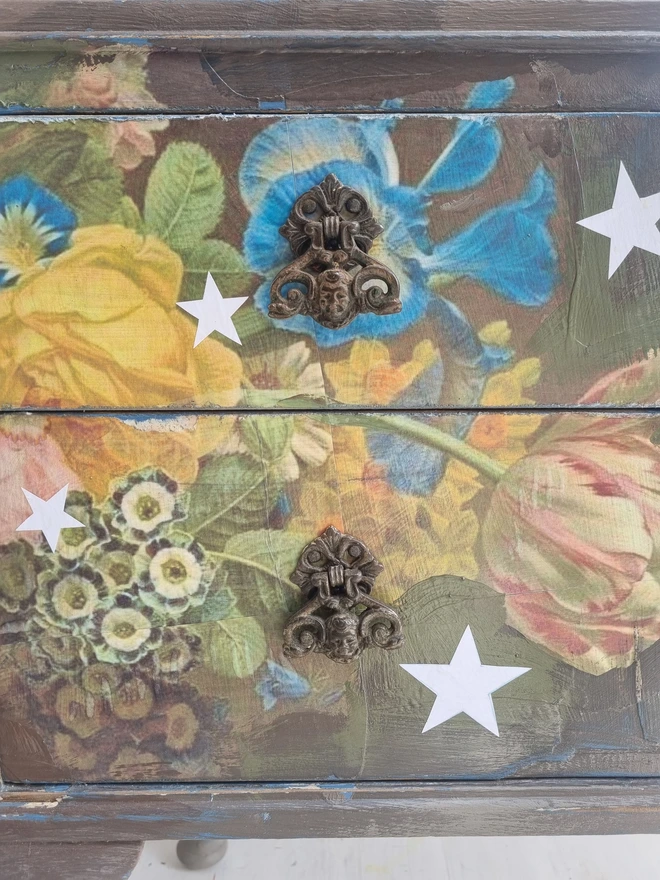 Vintage painted dressing table and chair. Painted in coffee grey and decorated using layered antique florals with yellow and blue accents and finished with hand-cut white paper stars. Text reads in blue 'think happy thoughts'. Heavily distressed finish.