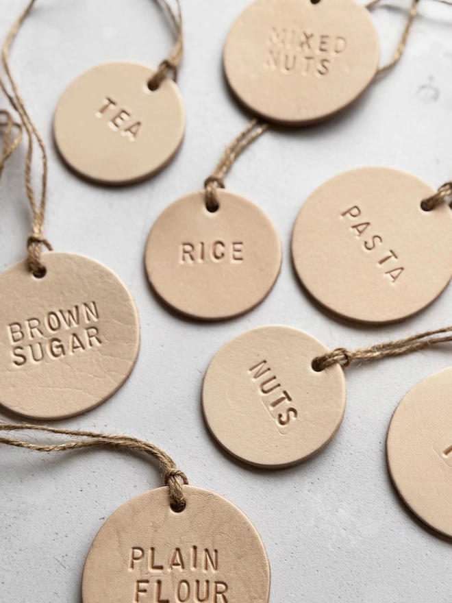 Rustic leather tag hand-stamped with "MILK", tied with jute twine on a glass bottle. Perfect for farmhouse kitchen décor, pantry organisation, or personalised gifting