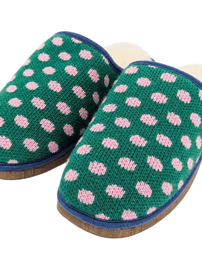 Lambswool & Sheepskin Slippers, a pair of colourful lambswool and sheepskin slippers sitting on a plain white surface. 