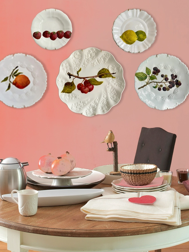 plate display on pink wall