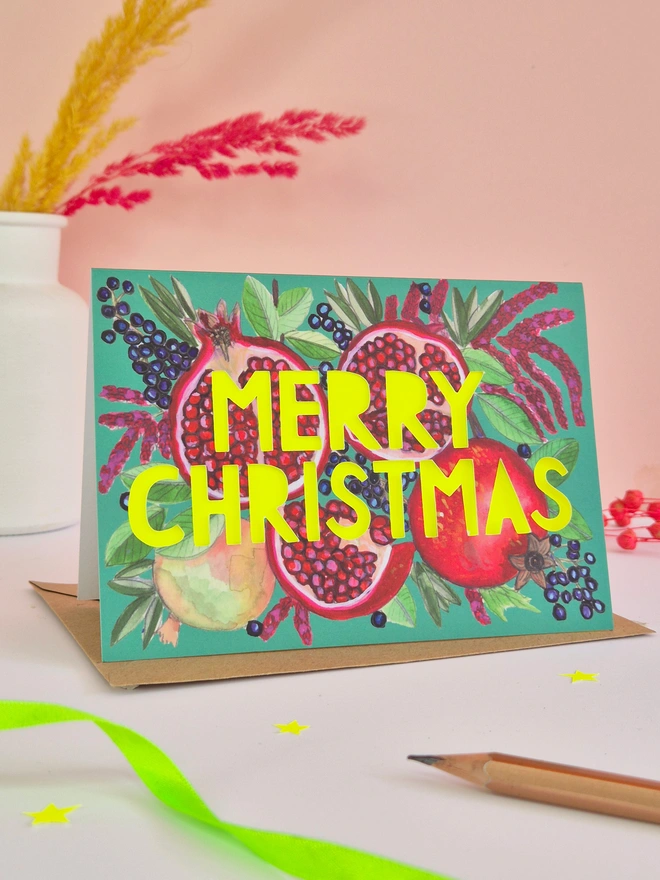 Pomegranate Christmas Card with Merry Christmas Paper cut slogan backed with neon yellow paper 