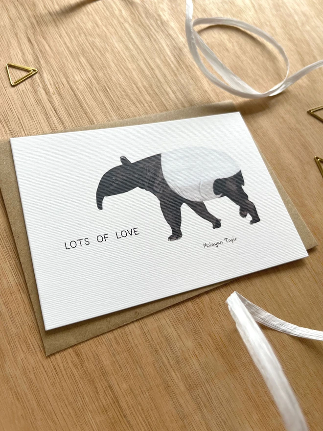  a greetings card featuring an illustration of a tapir with the text “lots of love”