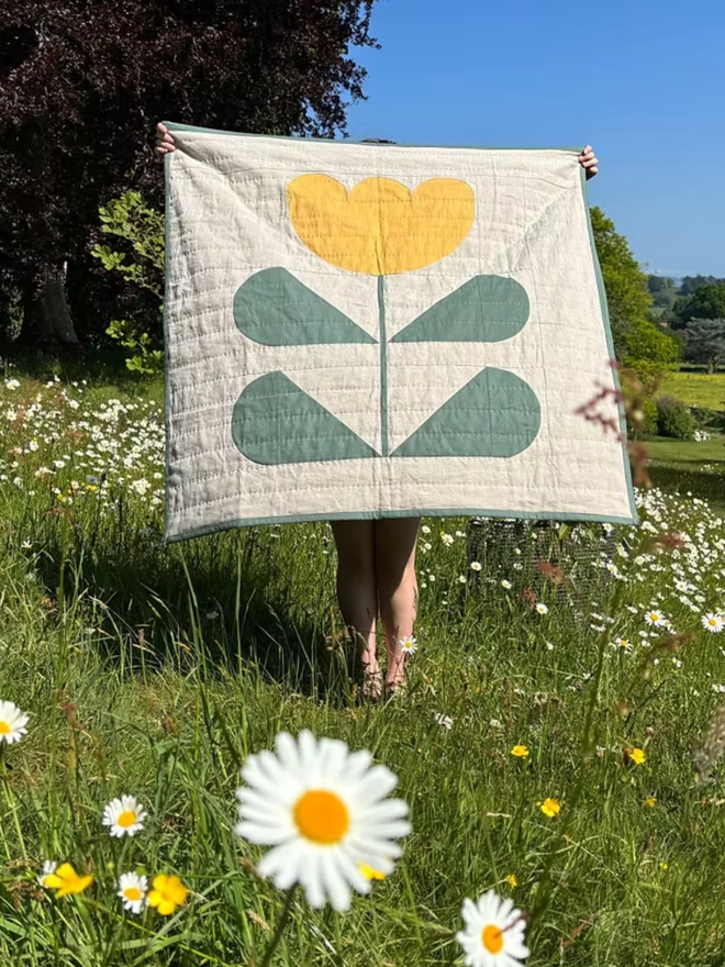 Grow & Bloom Yellow Quilt. A white, green and yellow quilt.