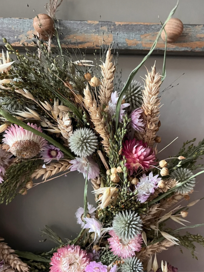 Dried Flower Cottage Wreath. A wreath made of dried flowers, hung up.