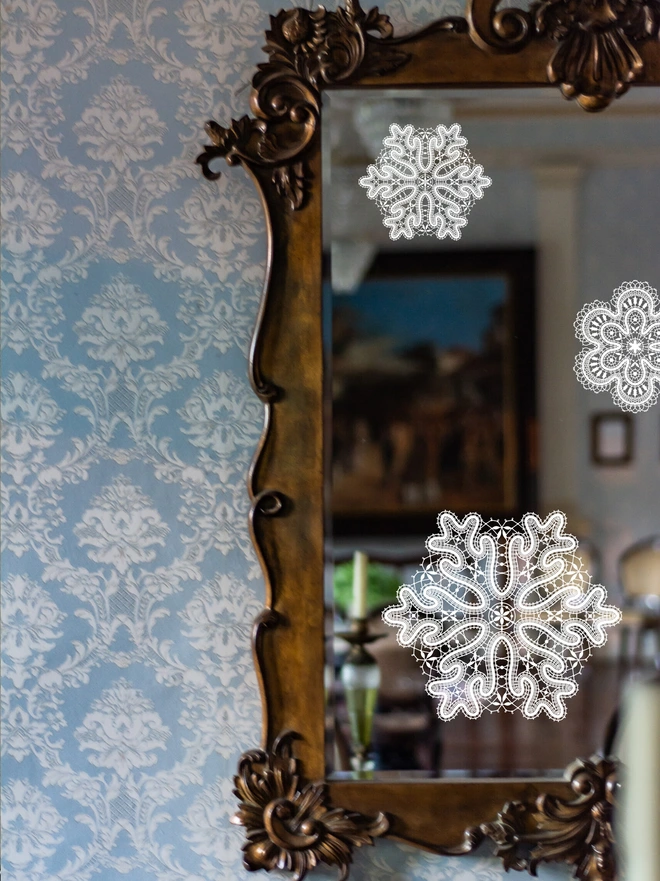 close up of a lace snowflake window sticker on a window