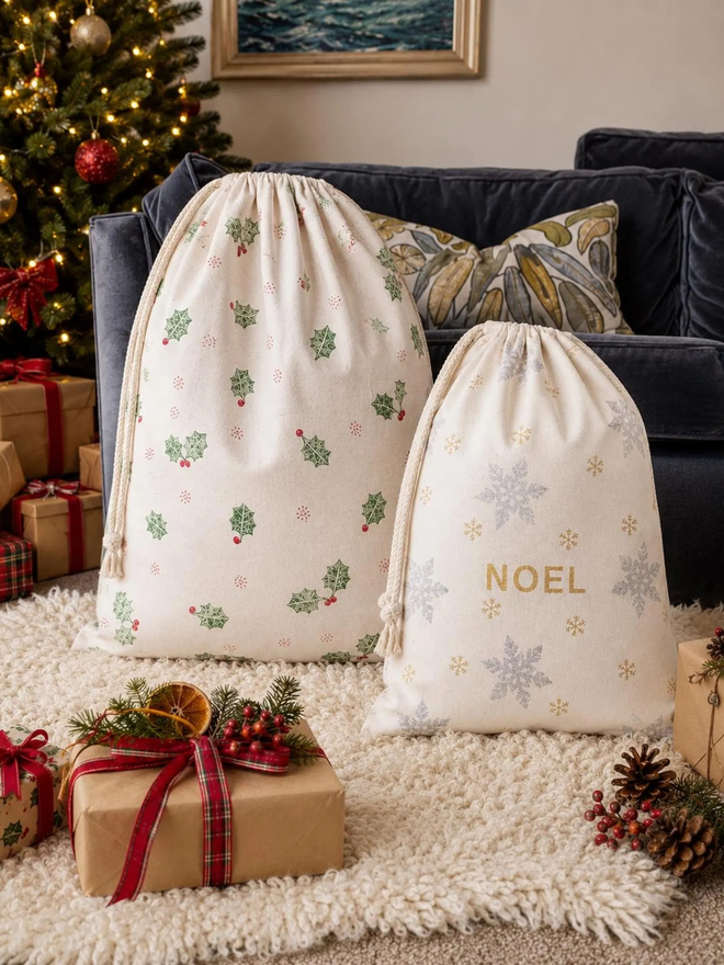 personalised drawstring christmas sack. two drawstring bags with printed christmas motifs and personalised names.