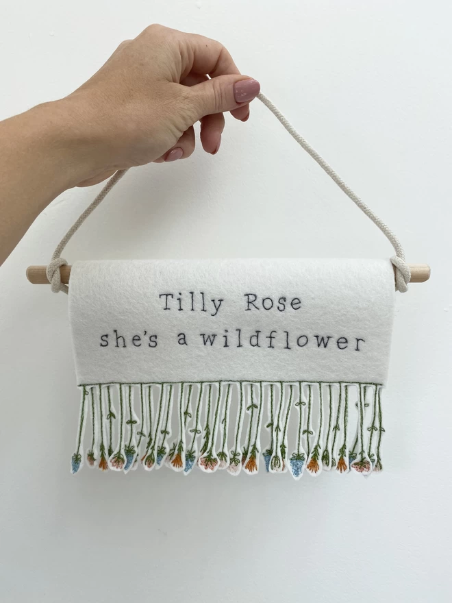 hand holding personalised shes a wildflower banner