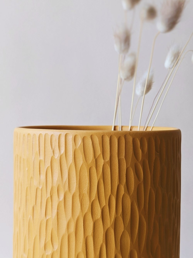 handmade textured yellow vase with dried flowers