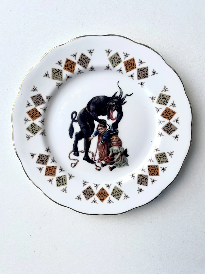 a naughty Christmas Krampus stealing a child, the image is victorian and is printed directly onto an ornate vintage plate