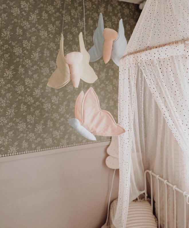 Butterfly Nursery Decoration, a colourful butterfly hanging decoration suspended in a kid's bedroom. 