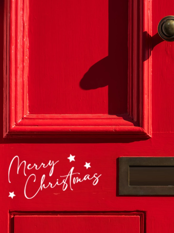 Merry christmas decal on red front door