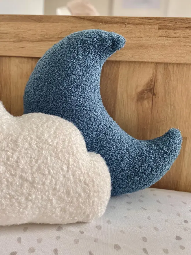 boucle moon pillow. a moon shaped pillow cushion in blue.