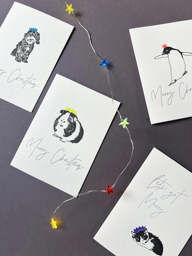 Letterpress cards illustrated with animals wearing Christmas cracker hats 