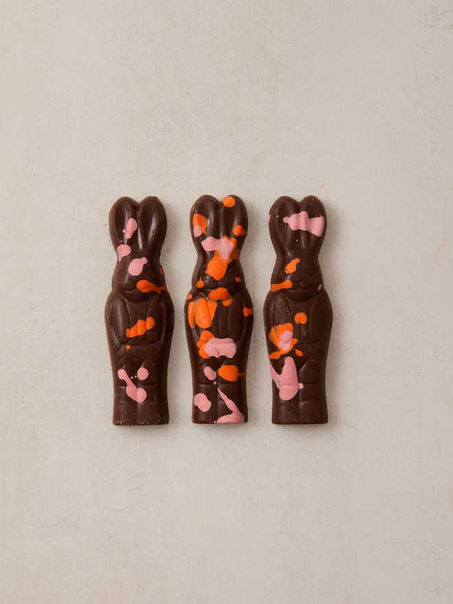 magic chocolate bunnies. a pack of three chocolate bunny rabbits photographed against a plain background.
