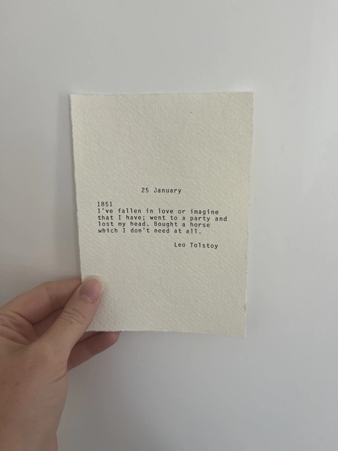 handmade typewriter print typed on cotton rag paper with deckled edges. The quote is Tolstoy