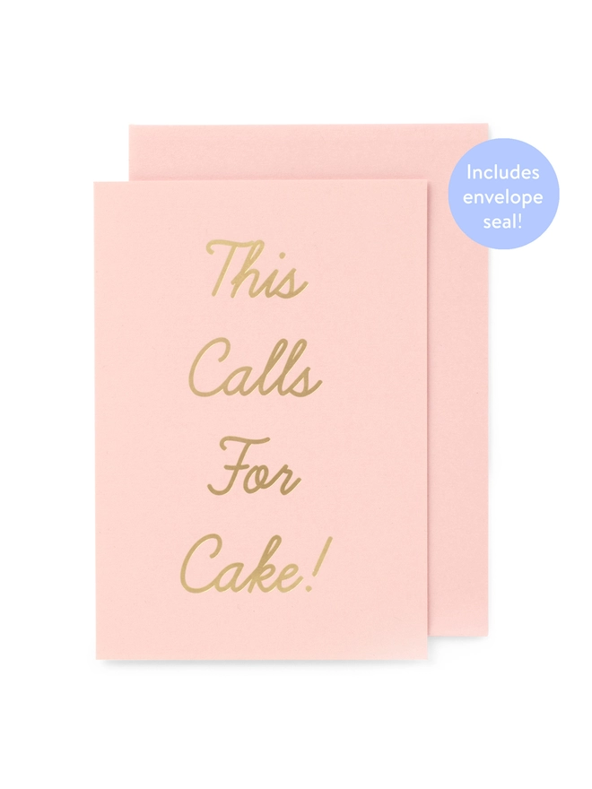 An elegant pink greeting card, that says 'This Calls For Cake!' in gold writing