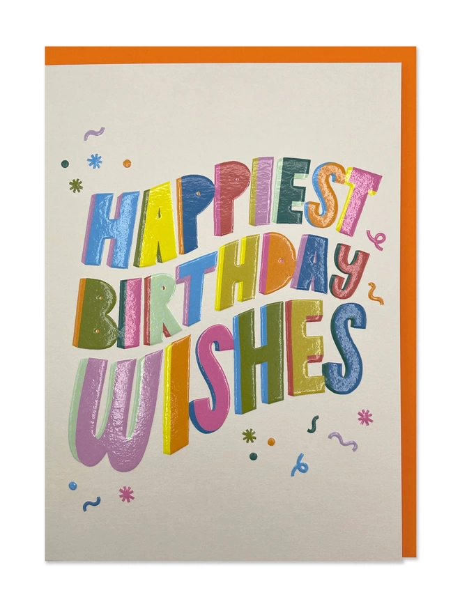 A colourful and bold Birthday card with ‘Happiest Birthday Wishes’ message in playful vibrant type on a cream background with colourful squiggles and confetti 