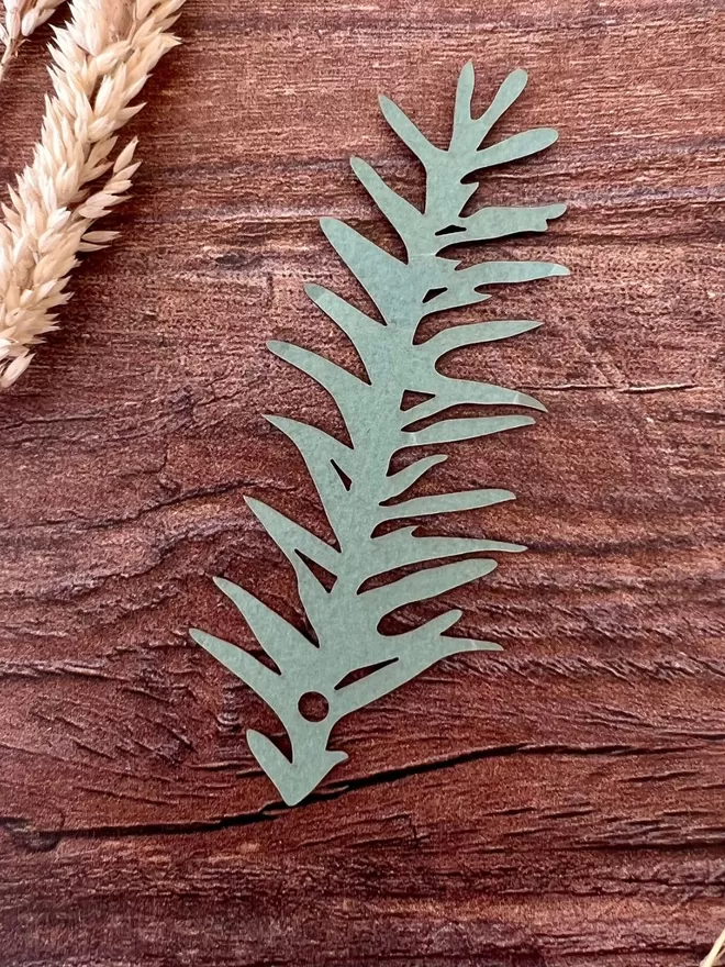 Closeup of sage green spruce paper napkin decoration Setting