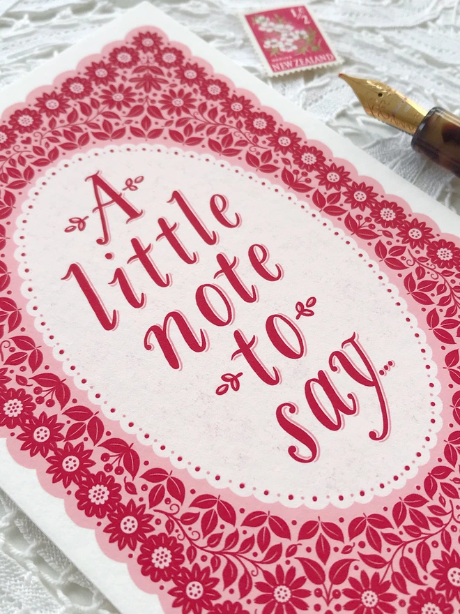 hand lettered card with a little note to say with pink floral pattern