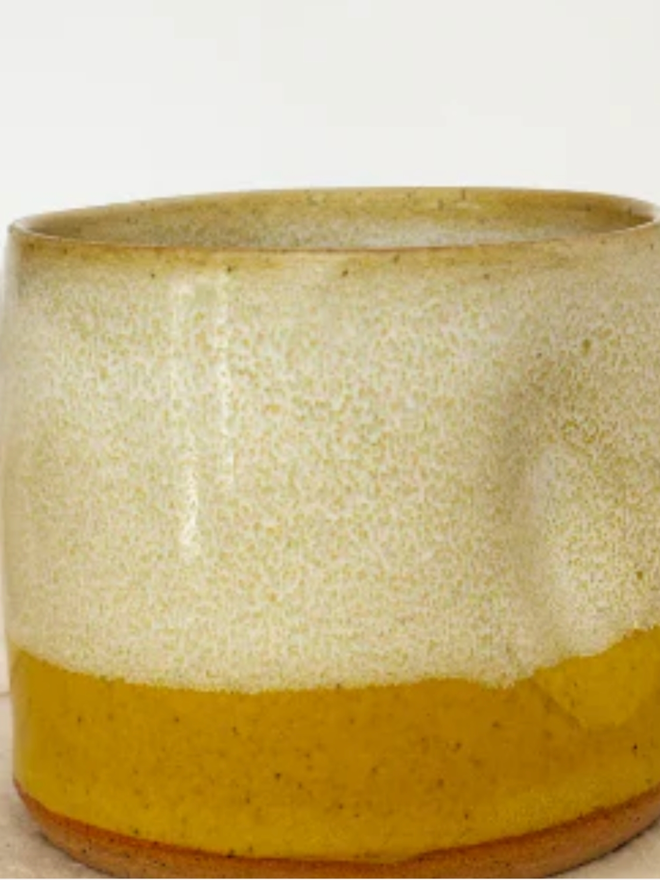 Pinch Mug. A close up of a Yellow Mini Pinch Mug against a white background. 