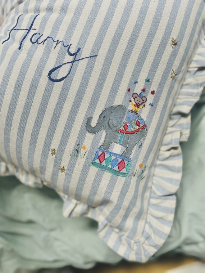 Hand Painted Giragge and ELephant celebrating the joy of the circus. Blue striped ruffle cushion with hand embroidered personalised name in the centre