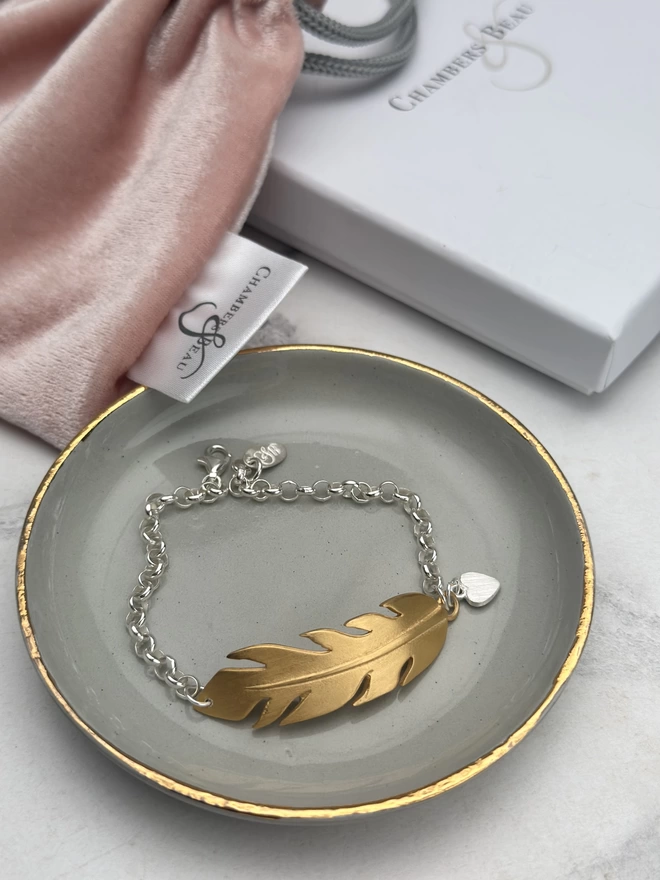 large gold feather charm bracelet on sterling silver belcher chain with silver mini heart charm