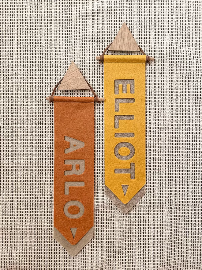 Two Tab Flags saying Arlo and Elliot. One orange and one yellow. 