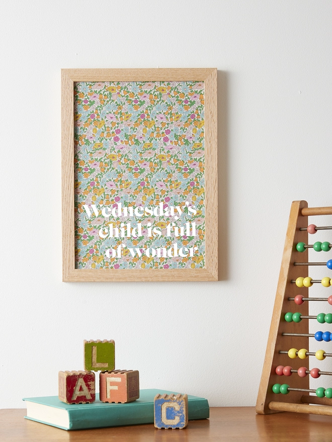 Wednesday's child is full of wonder picture on Liberty fabric with white writing