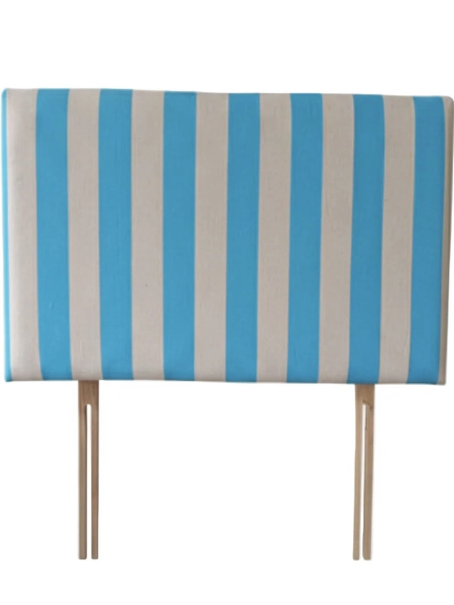 Hand Painted Upholstered Linen Headboard In Stripe Print, a neon blue striped headboard sitting against a white background. 